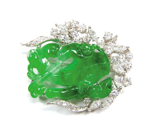 Platinum brooch with carved green jade surrounded by round brilliant and marquise cut diamonds, approximately. 1.90 twd., 10.0 dwt. Estimate: $700-$1,000. Image courtesy of Pook & Pook.
